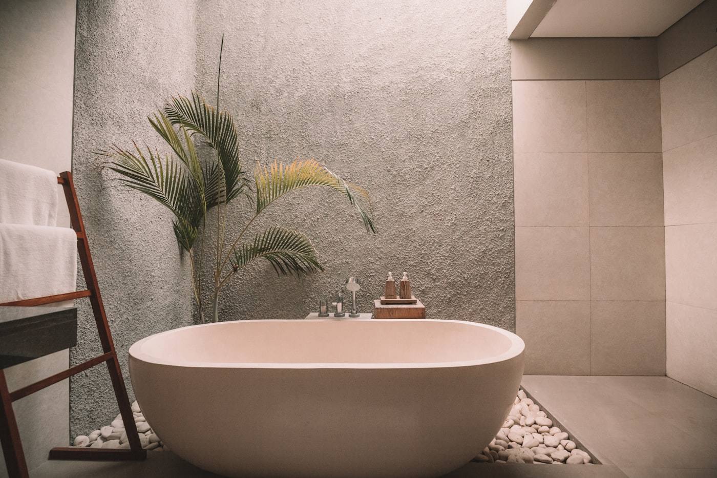Freestanding soaking tub in a calm, modern bathroom